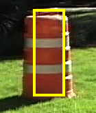 An identified orange & white construction barrel